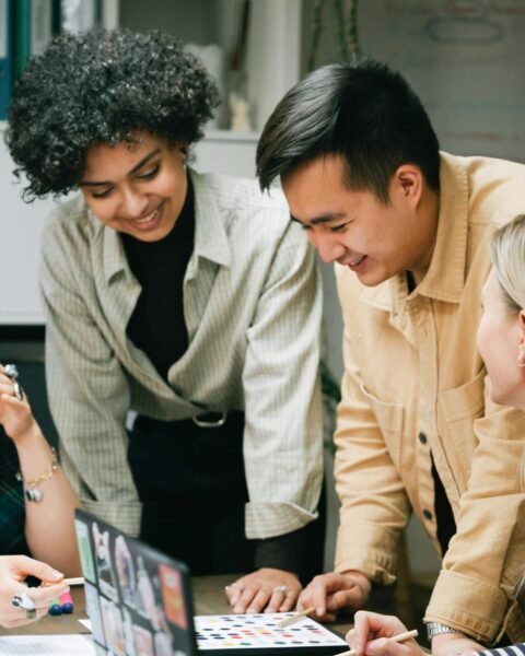 A diverse team collaboratively brainstorming on a project in a modern office setting.